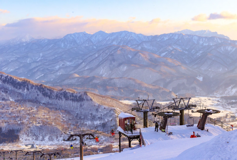 Chairlifts with a mountain range in the distance