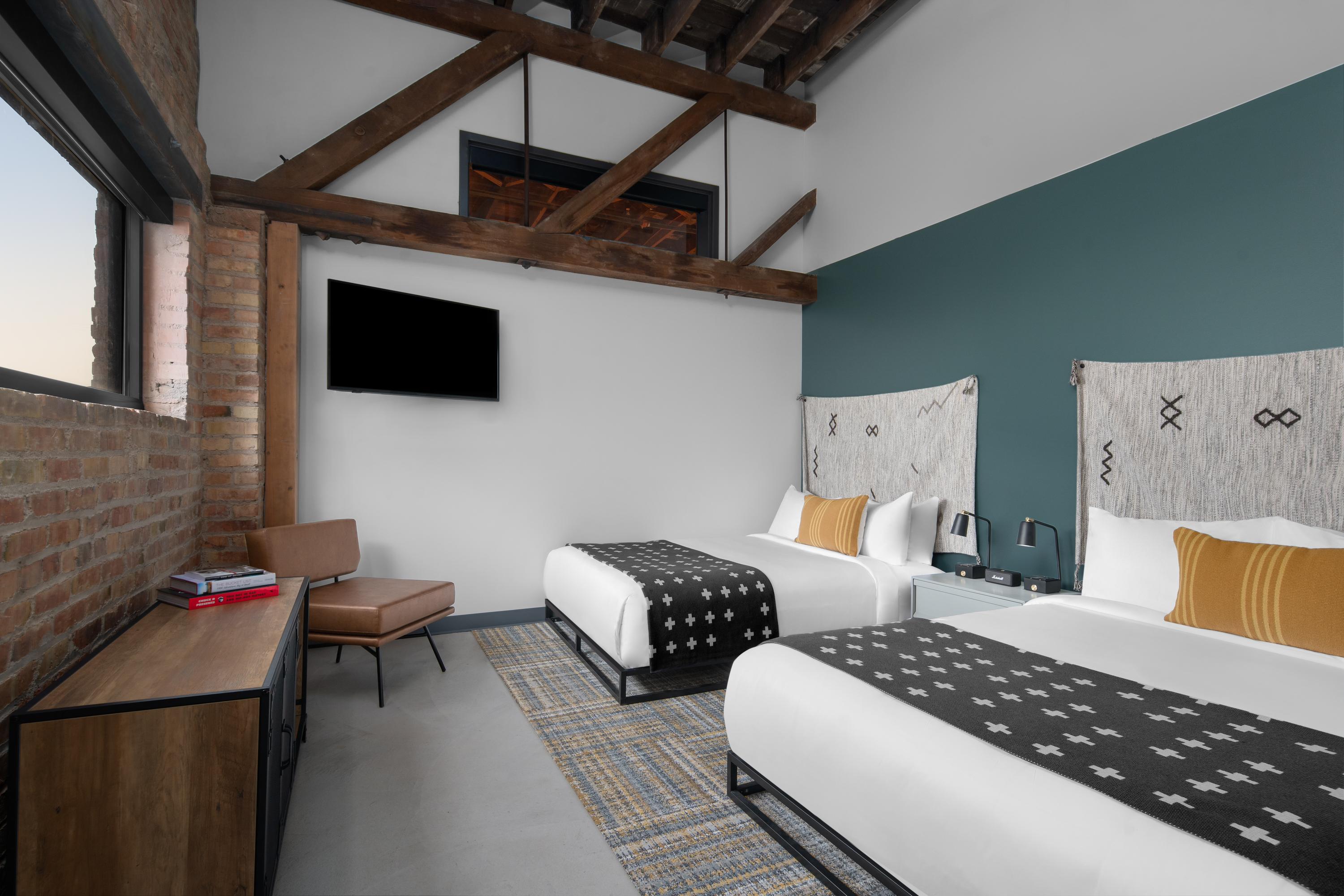 Room with a lofted ceiling and two queen beds