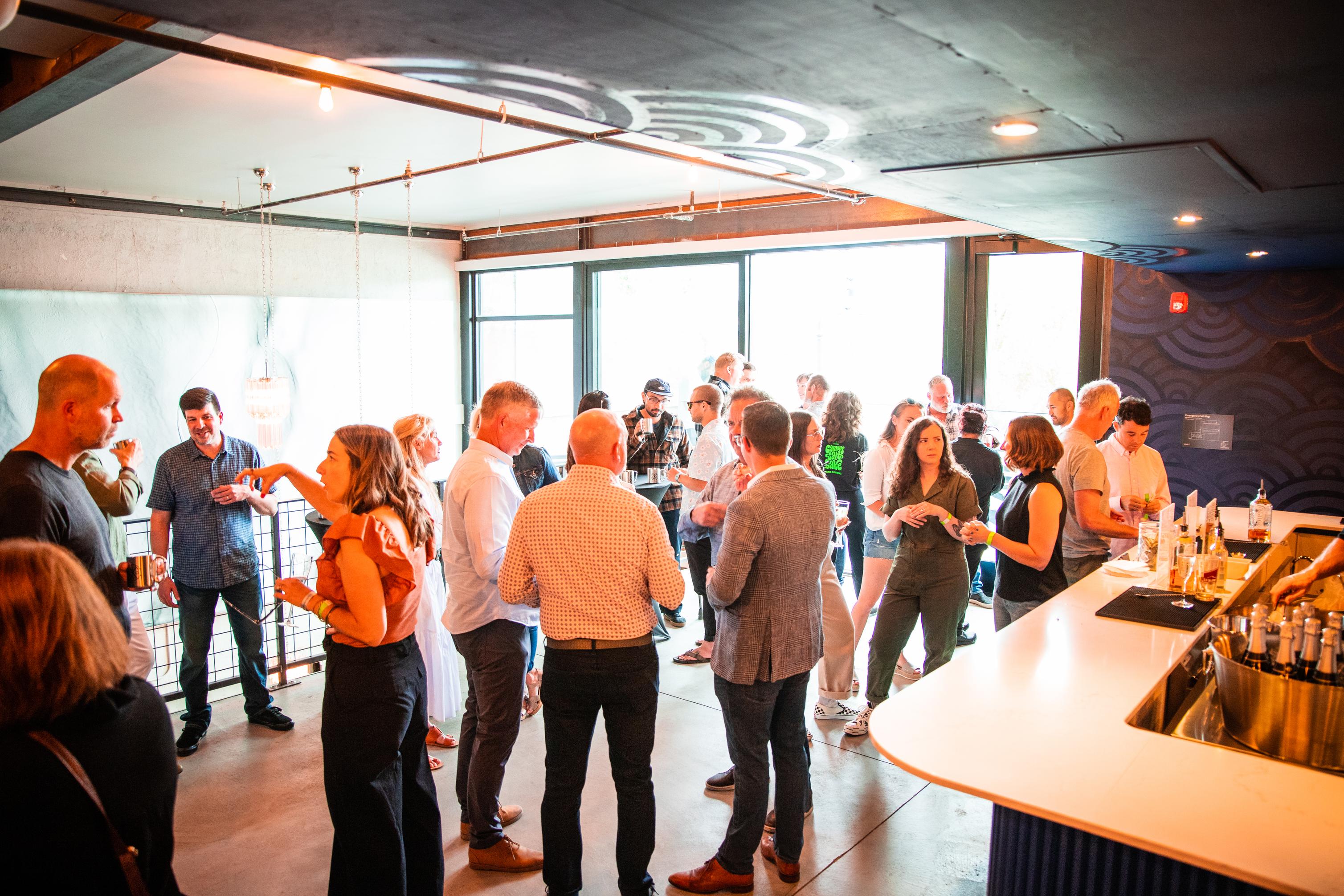 People mingling at an event in the lobby