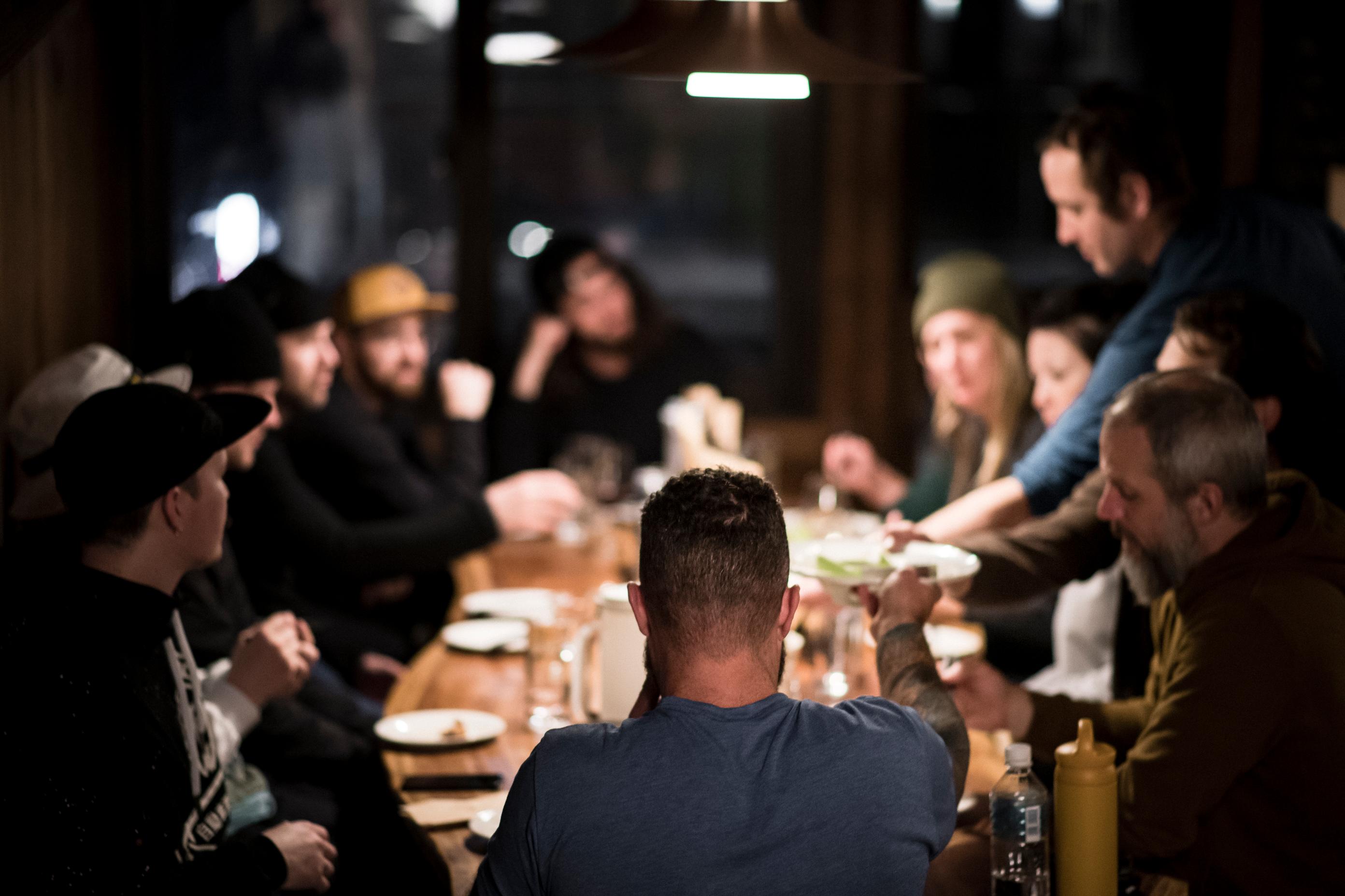 People gathered around glasses in a ski village