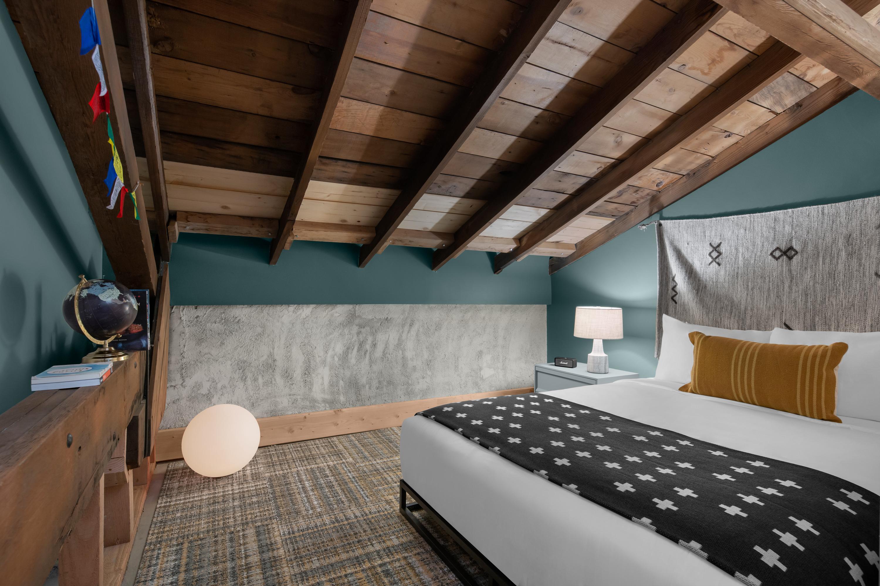 Bedroom with queen bed and exposed beams 