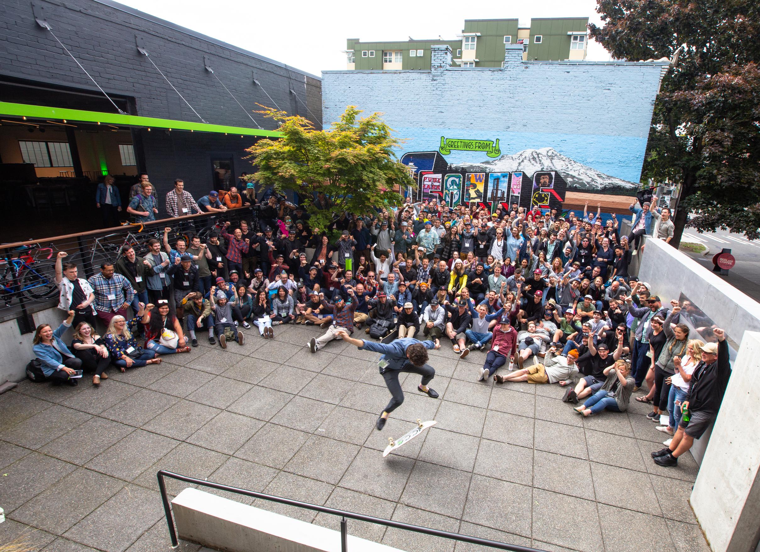 evo team watching a skateboarder in a space outside the store