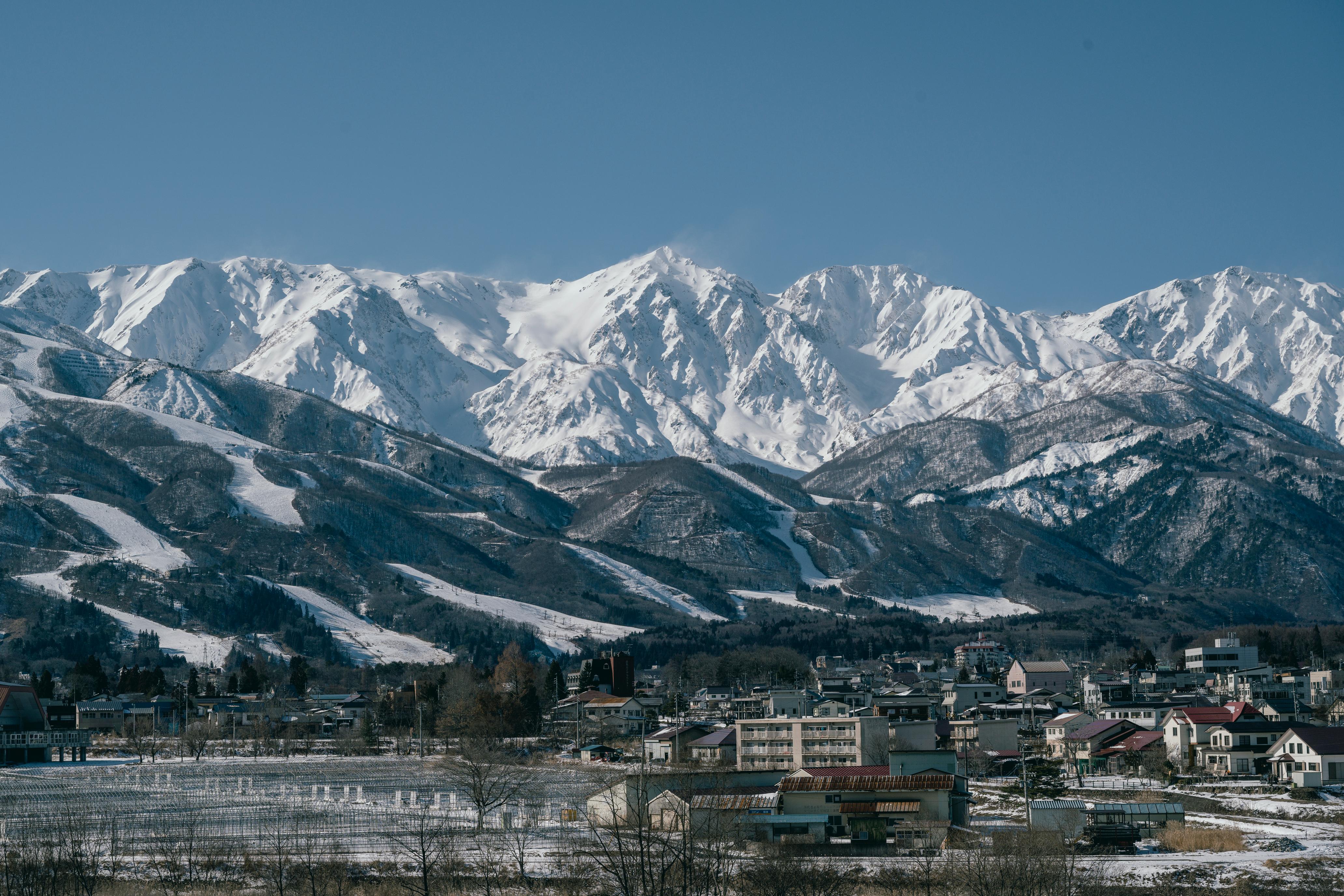 Town in the foreground with snowy mountains in the background